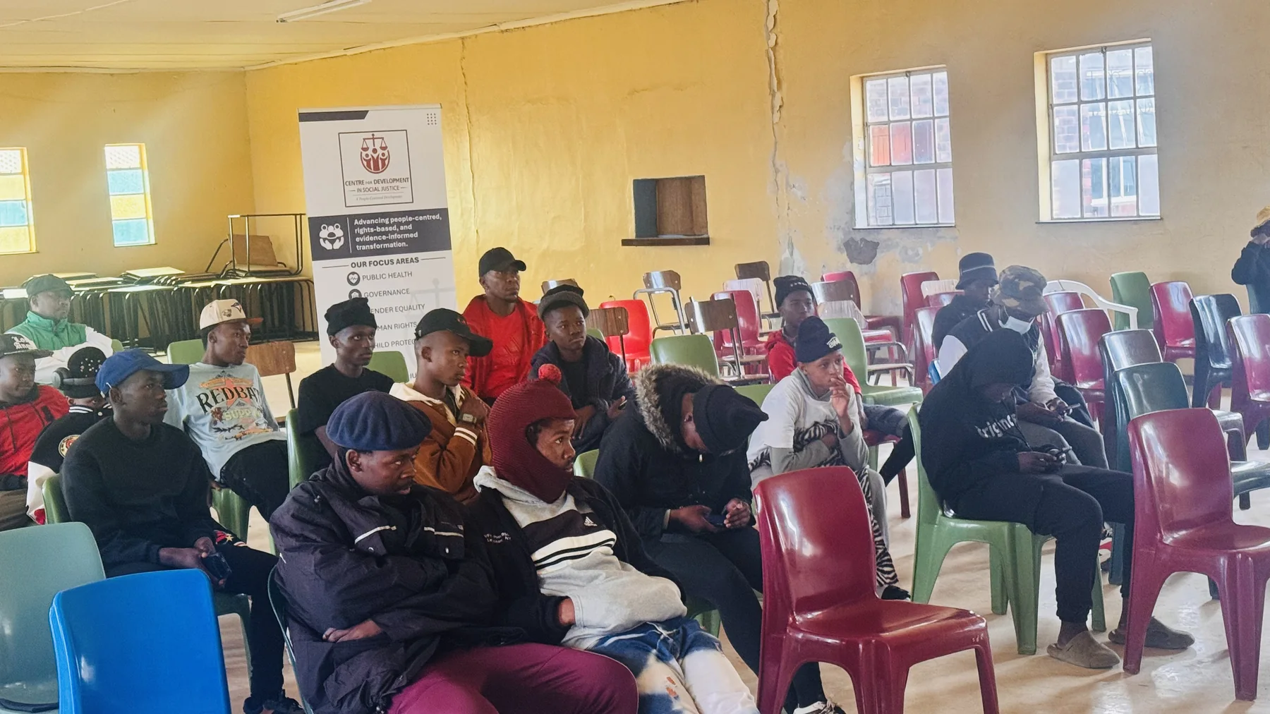 Young people listening during the CDSJ-supported gender equality session in Mapoteng